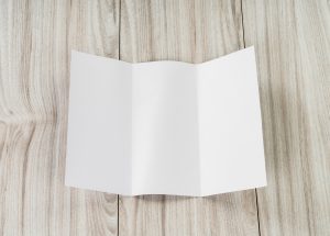 Trifold white template paper on wood texture
